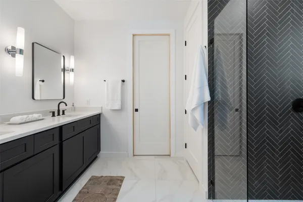 a bathroom with a double vanity sink and mirror