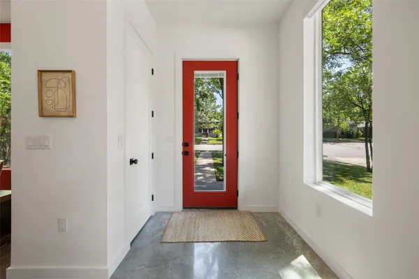 a view of an entryway with wooden floor and windows