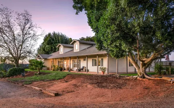 a front view of a house with a yard and a garage