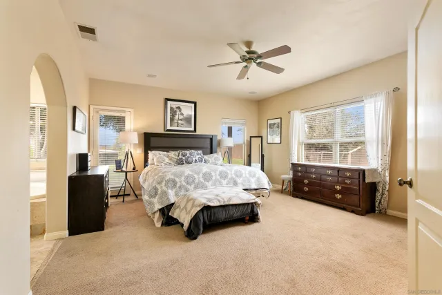 a spacious bedroom with a bed and a window