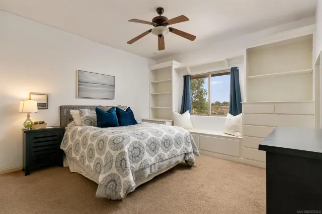a spacious bedroom with a bed and a chandelier