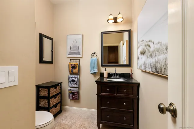 a bathroom with a toilet a sink and mirror