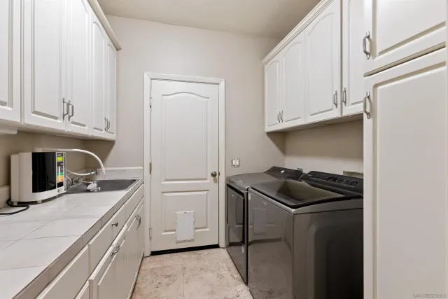 a kitchen with a stove and white cabinets