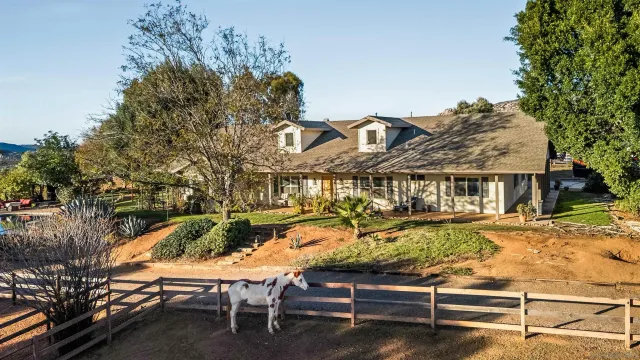 a view of a house with backyard porch and sitting area