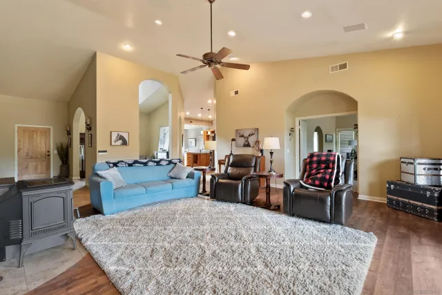 a living room with furniture fireplace and wooden floor