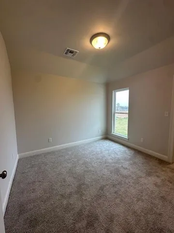 an empty room with windows and closet