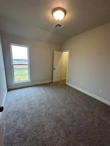 an empty room with a empty space and windows