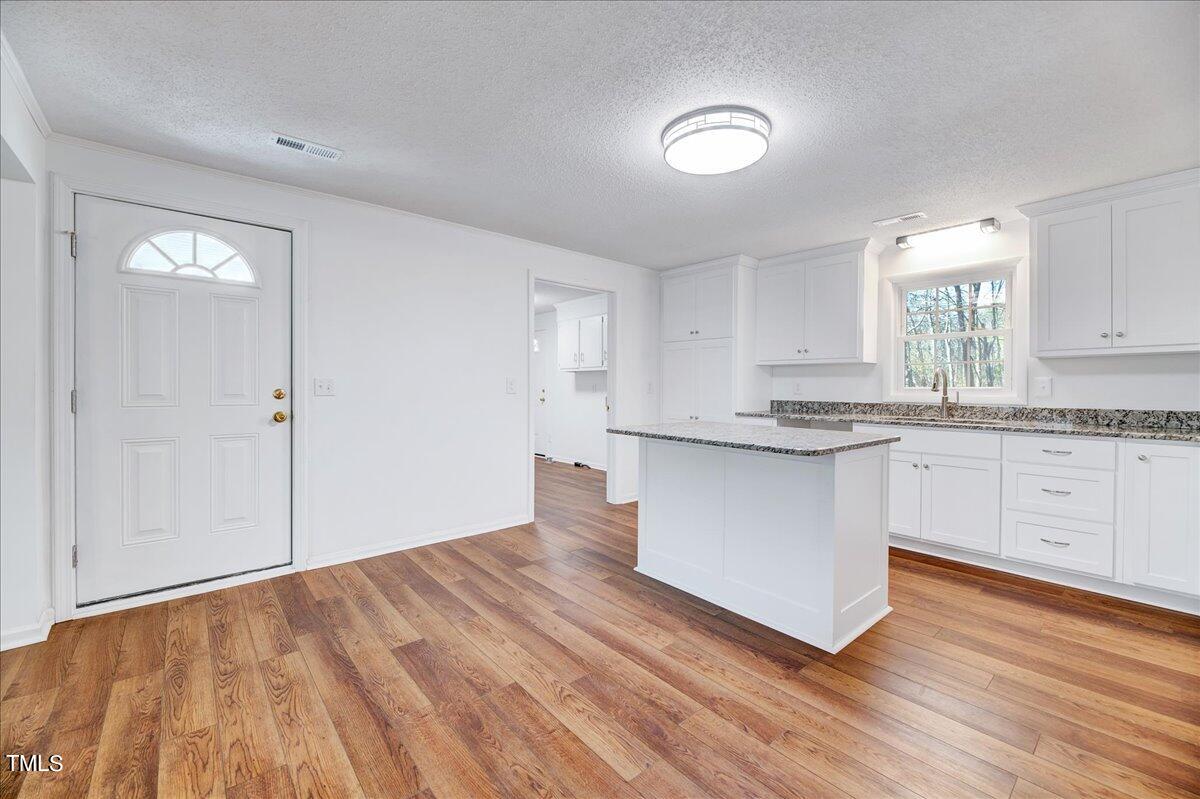 103 Allendale Road Four Oaks, NC 27524 - Photo 14 of 44 a kitchen with granite countertop white cabinets and white appliances