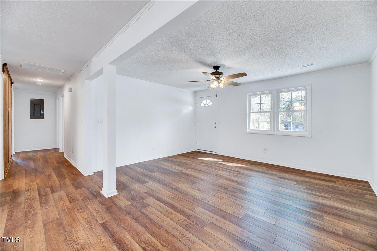 103 Allendale Road Four Oaks, NC 27524 - Photo 18 of 44 a view of an empty room with wooden floor and a window