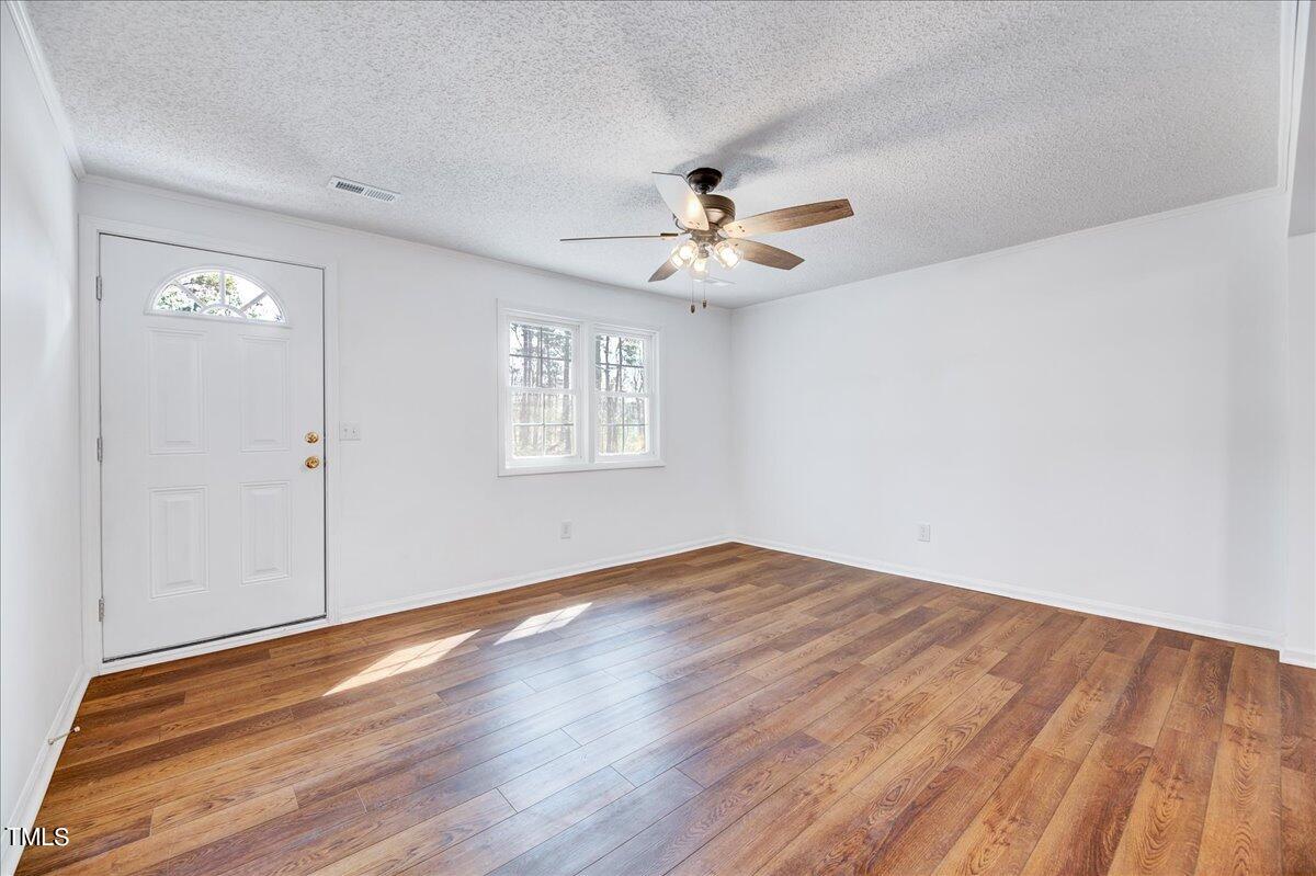 103 Allendale Road Four Oaks, NC 27524 - Photo 19 of 44 wooden floor in an empty room with a window