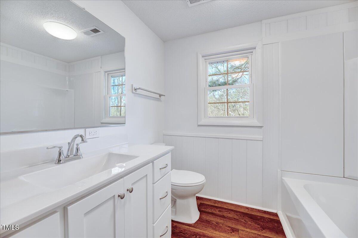 103 Allendale Road Four Oaks, NC 27524 - Photo 21 of 44 a bathroom with a sink a toilet and a window