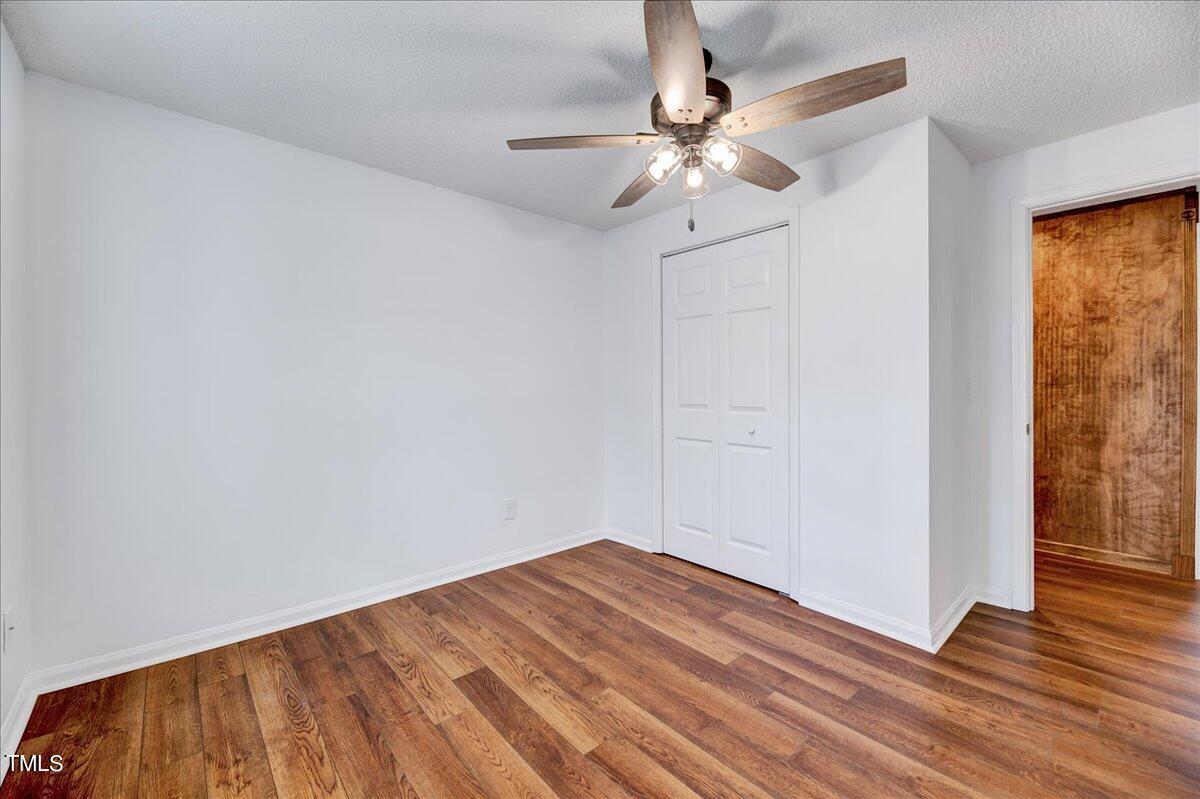 103 Allendale Road Four Oaks, NC 27524 - Photo 24 of 44 a view of a room with wooden floor and fan