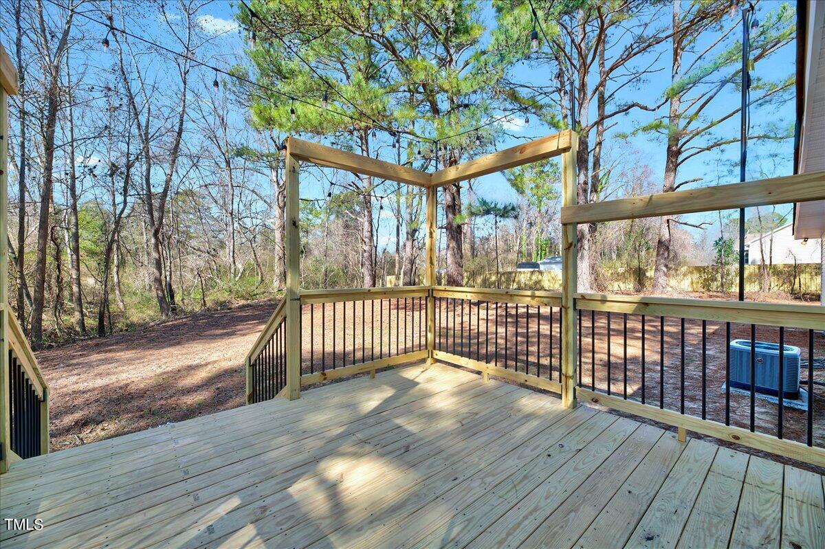 103 Allendale Road Four Oaks, NC 27524 - Photo 5 of 44 a view of a porch with wooden floor and bench