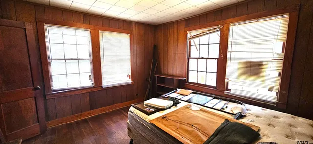 a bedroom with furniture and windows