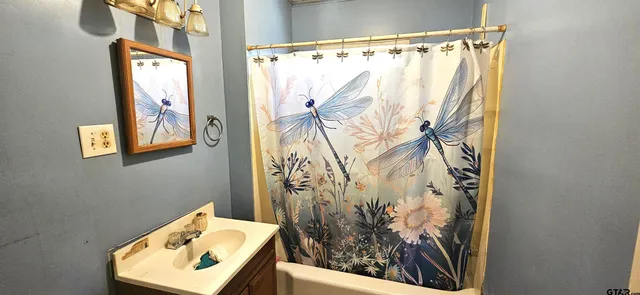 a bathroom with a bathtub and shower curtain