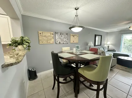 a living room with couches and painting on the wall