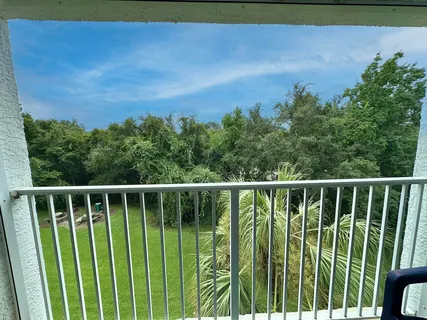 a bedroom with a bed and glass door