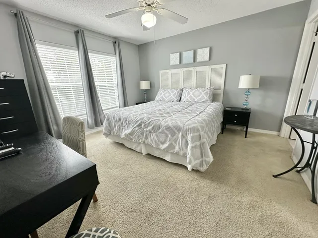 a bedroom with a bed and a night stand