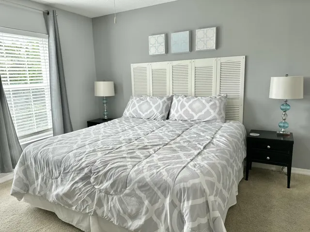 a bedroom with a bed and a chandelier