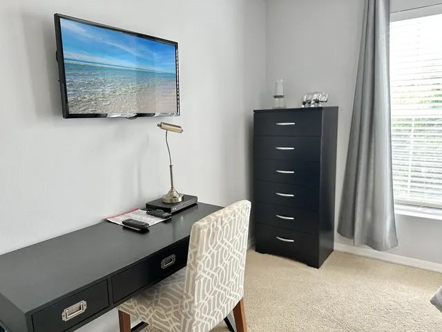 a hallway with a couch and a potted plant