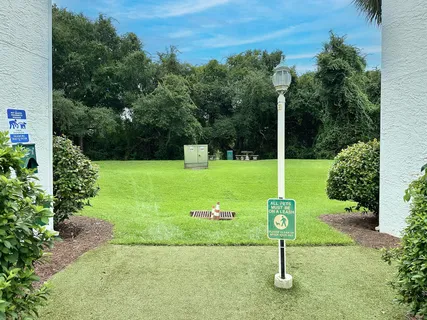 an outdoor space with patio and white fence