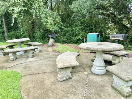 a view of a building with garden and parking space