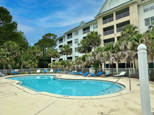 a view of a table and chairs in backyard