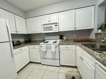 a table with a stove and a wooden cabinets