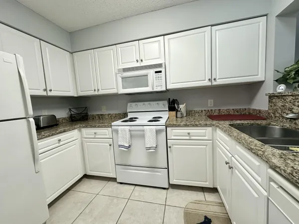 a table with a stove and a wooden cabinets