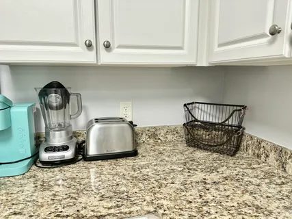 a kitchen with cabinets appliances a sink and a counter top space