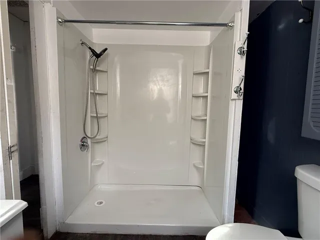 a bathroom with a glass shower door