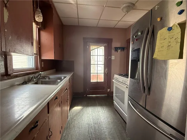 a kitchen with a sink stove and refrigerator