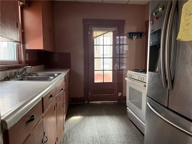 a kitchen with a refrigerator and a sink