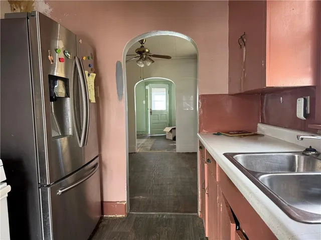 a kitchen with a refrigerator and a sink