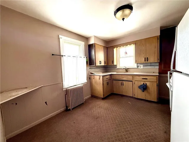 a kitchen that has a sink a window and stainless steel appliances