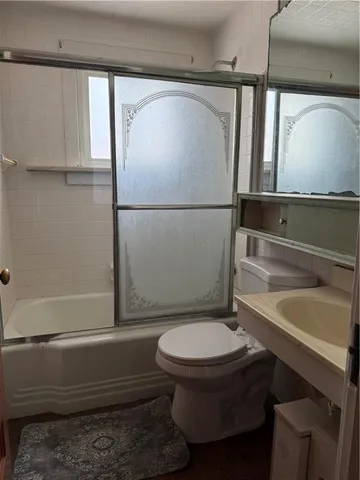 a bathroom with a toilet a sink and bathtub