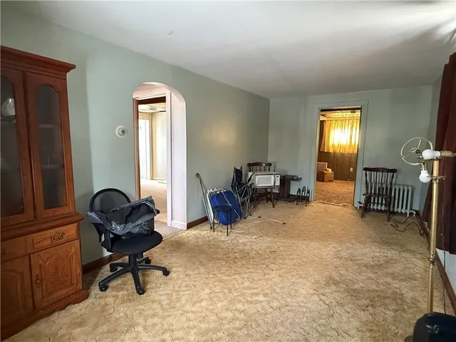 a view of a livingroom with workspace and a window