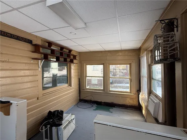 a view of a room that has a bed and a window