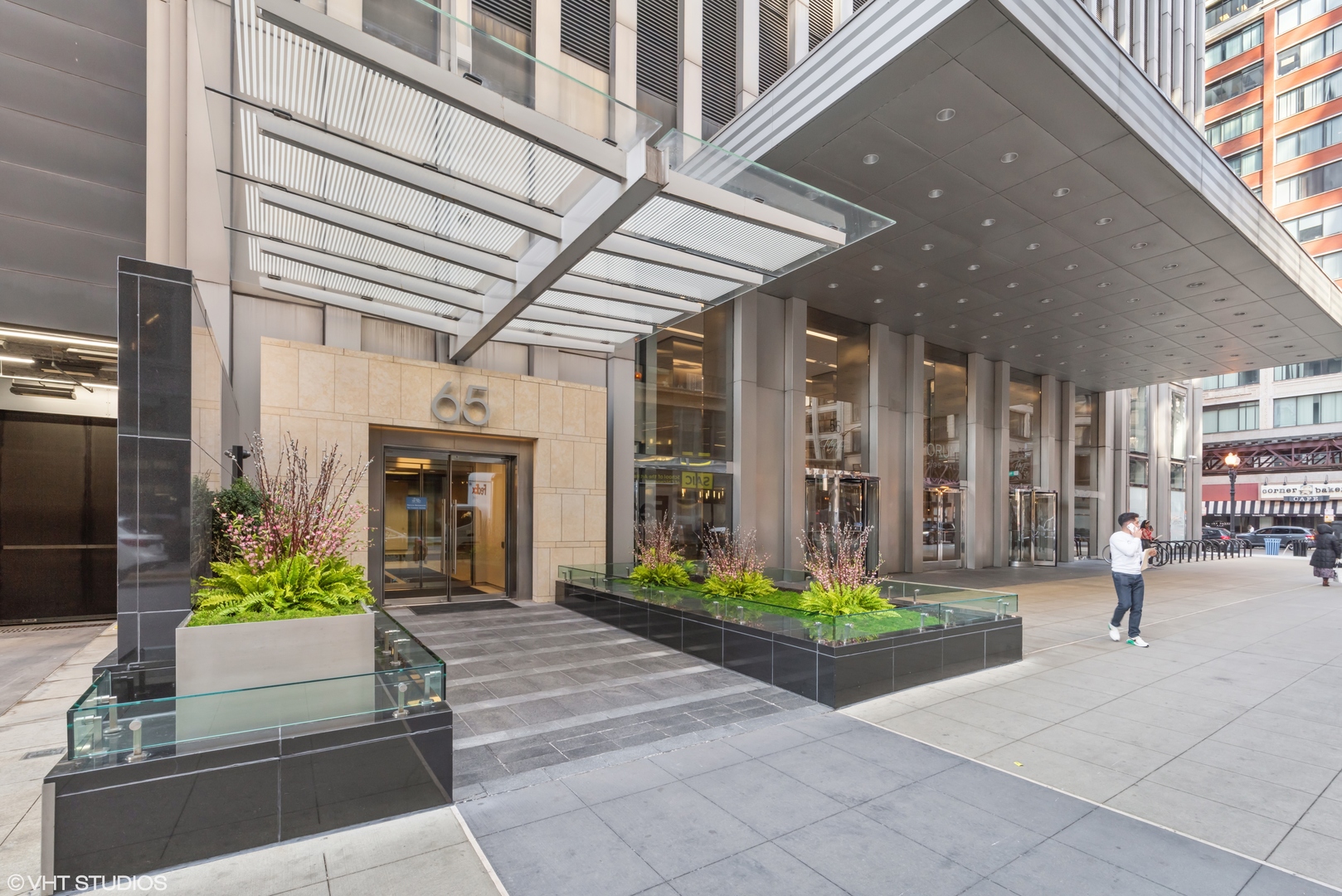 a front view of a building with potted plants