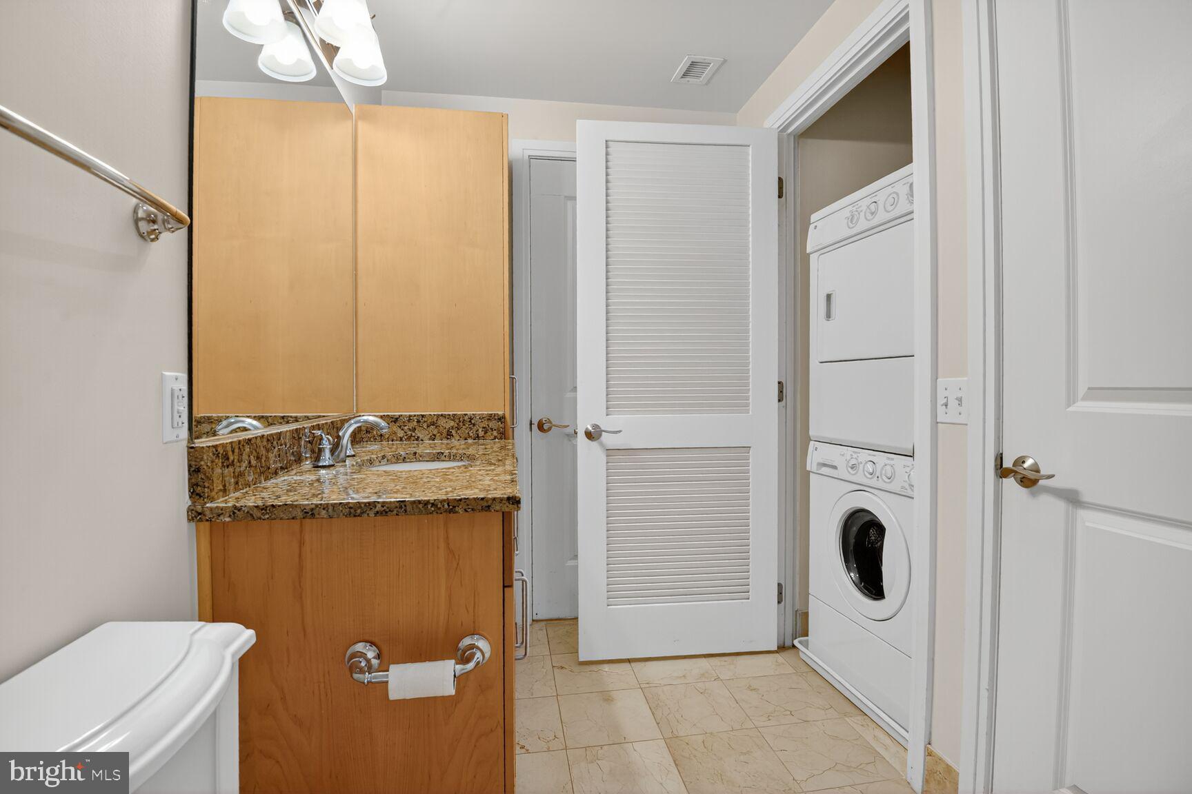 8220 Crestwood Heights Drive, Unit 418 McLean, VA 22102 - Photo 13 of 28 Washer-Dryer Stacked in Bathroom