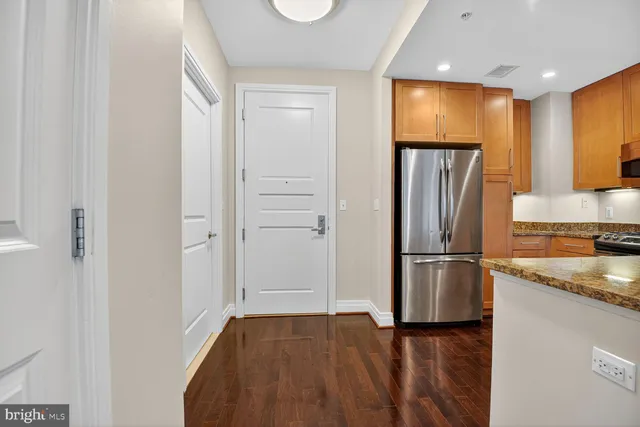 a kitchen with a refrigerator and a sink