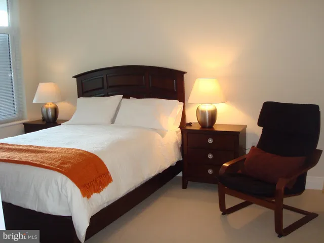 a bedroom with a bed and chair