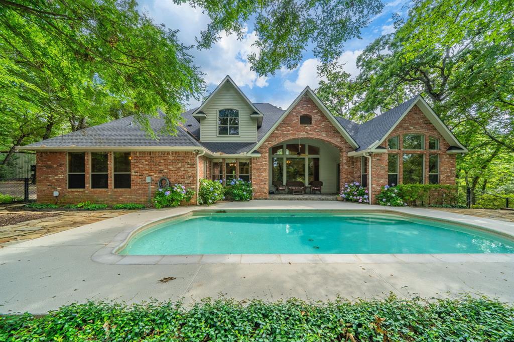 7451 County Road 1509 Athens, TX 75751 - Photo 23 of 36 a front view of a house with a yard and garage