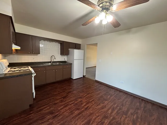 a view of kitchen with sink and wooden floor