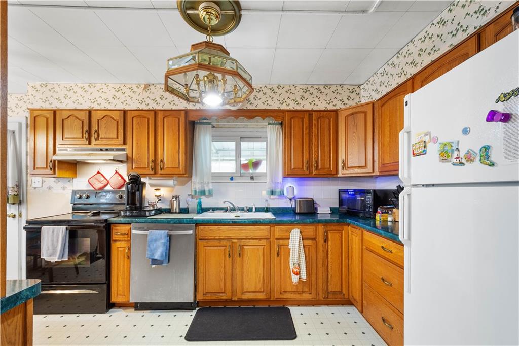 330 Main Street Richeyville, PA 15358 - Photo 11 of 28 a kitchen with stainless steel appliances granite countertop a stove a sink and a microwave