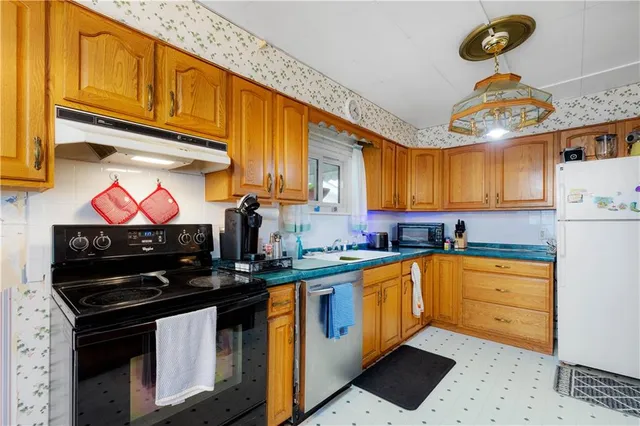 a kitchen with stainless steel appliances kitchen island granite countertop a sink and cabinets