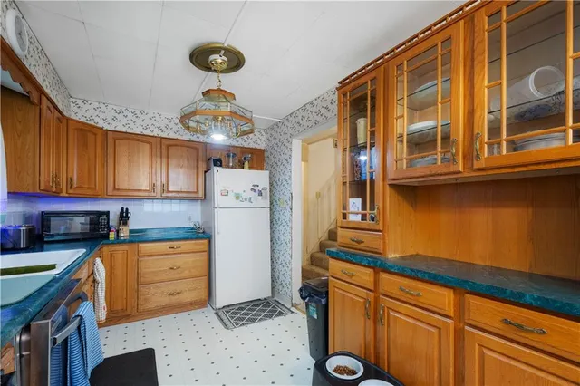 a kitchen with stainless steel appliances granite countertop a stove a sink dishwasher and cabinets with wooden floor