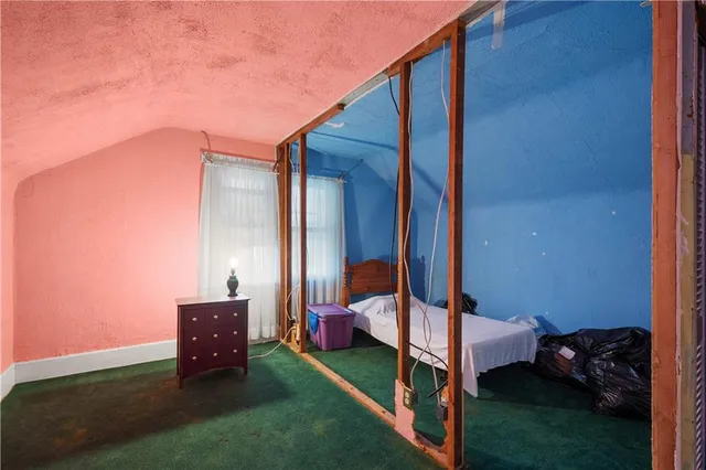 a bed sitting in a room next to a yard