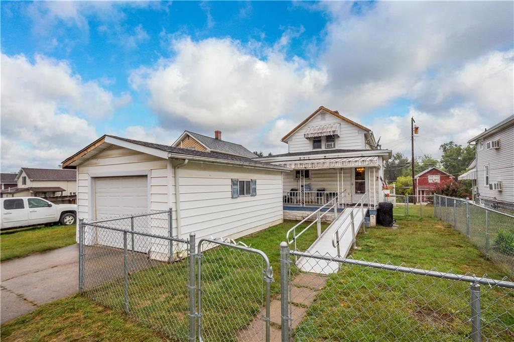 330 Main Street Richeyville, PA 15358 - Photo 24 of 28 a view of a white house next to a yard with potted plants