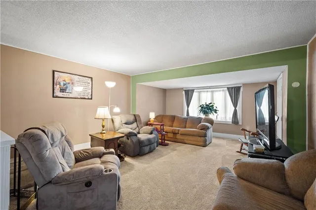 a living room with furniture chess board and a window